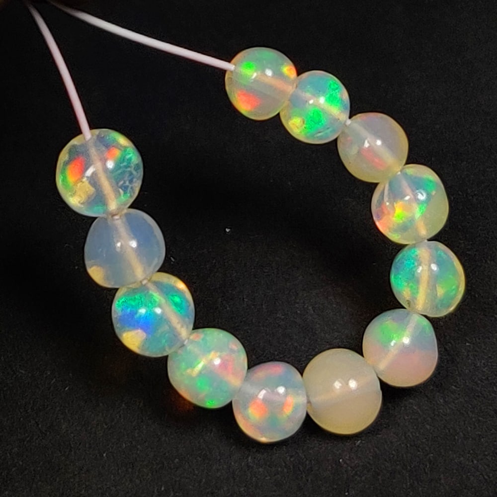 2.21 Ct Natural Multi-Color Welo Opal Round Beads: Weight - 2.21 Ct / Dimensions - 3.30 - 3.70 mm / 12 Pc's / Shape - Round Beads / Color - Multicolor / Clarity - Translucent / Origin - Ethiopia / Comments - None