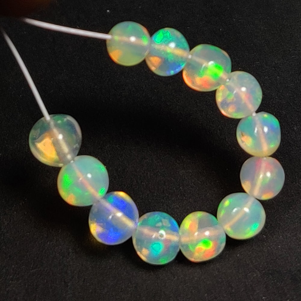 2.37 Ct Natural Multi-Color Welo Opal Round Beads: Weight - 2.37 Ct / Dimensions - 3.20 - 3.90 mm / 12 Pc's / Shape - Round Beads / Color - Multicolor / Clarity - Translucent / Origin - Ethiopia / Comments - None