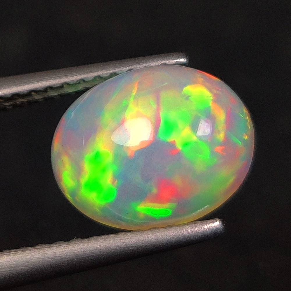 1.83 Ct Natural Multicolor Welo Opal Top Fire Oval Cab: Weight - 1.83 Ct / Size - 10.20 x 8.20 x 5.00 mm / Shape - Oval Cab / Color - Multicolor / Clarity - Translucent / Origin - Ethiopia / Treatment - None