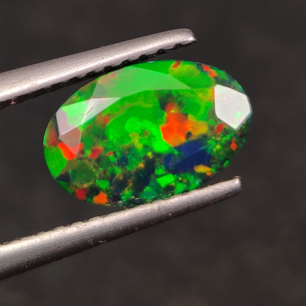 1.12 Ct Natural Black Fire Opal Oval Cut: Weight - 1.12 Ct / Dimensions - 9.80 x 6.50 x 3.70 mm / Shape - OVal Cut / Color - Black / Clarity - Translucent / Origin - Ethiopia / Treatment - Color Smoked