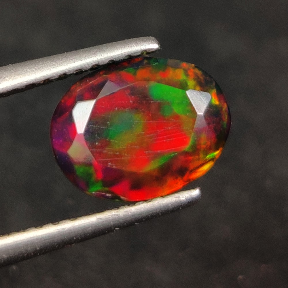 1.20 Ct Natural Black Fire Opal Oval Cut: Weight - 1.20 Ct / Dimensions - 9.10 x 7.10 x 4.10 mm / Shape - Oval Cut / Color - Black / Clarity - Translucent / Origin - Ethiopia / Treatment - Color Smoked