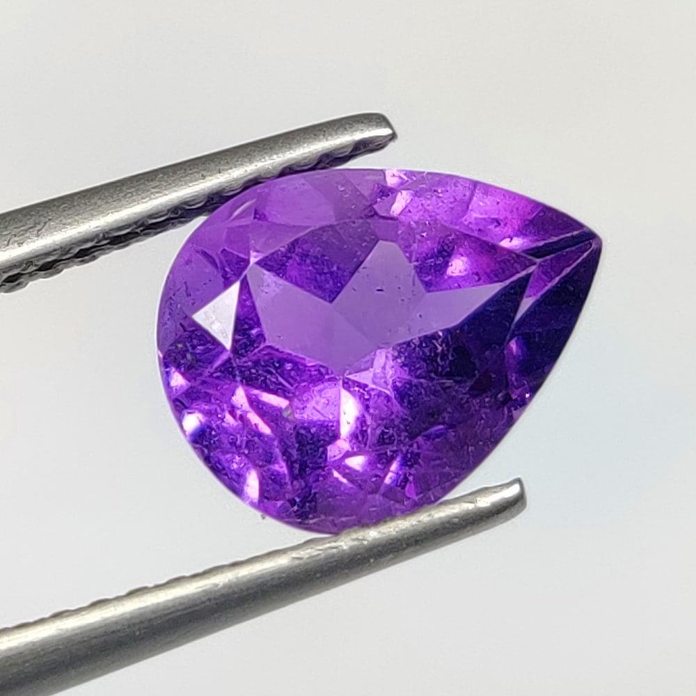 2.32 Ct Natural Purple Amethyst Pear Cut: Weight - 2.32 Ct / Dimensions - 10.10 x 8.00 x 5.80 mm / Shape - Pear Cut / Color - Purple / Clarity - VVS / Origin -Brazil / Treatment - Heated