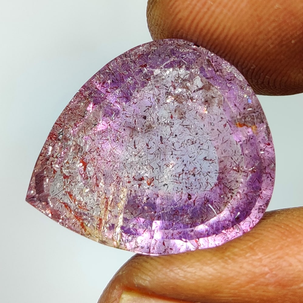 20.98 Ct Natural Rutile Amethyst Quartz Pear Cut: Weight - 20.98 Ct / Size - 20.70 x 18.00 x 10.60 mm / Shape - Pear Cut / Clarity - Transparent / Origin - Norway / Treatment - None