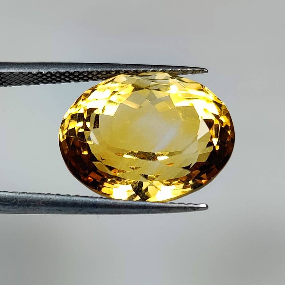 12.64 Ct Natural Yellow Citrine Oval Cut: Weight - 12.64 Ct / Dimensions - 16.30 x 12.90 x 10.30 mm / Shape & Cut - Oval Cut / Color - Yellow / Transparency - VVS / Origin - Brazil / Comments - Heated