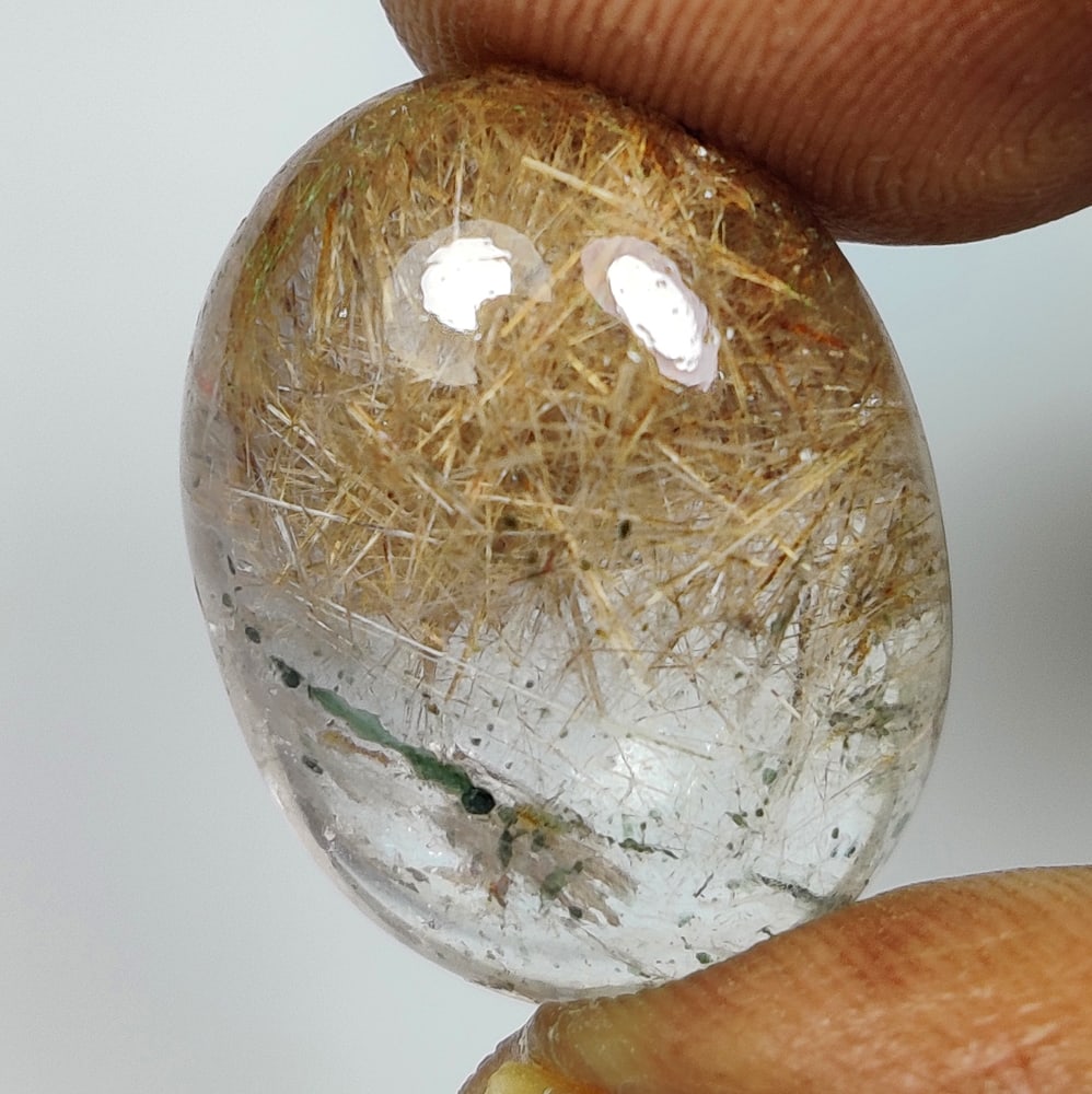 22.29 Ct Natural Rutile Quartz Oval Cab: Weight - 22.29 Ct / Size -20.20 x 15.60 x 10.00 mm / Shape - Oval Cut / Color - Green / Clarity - Transparent / Origin - Norway / Treatment - None