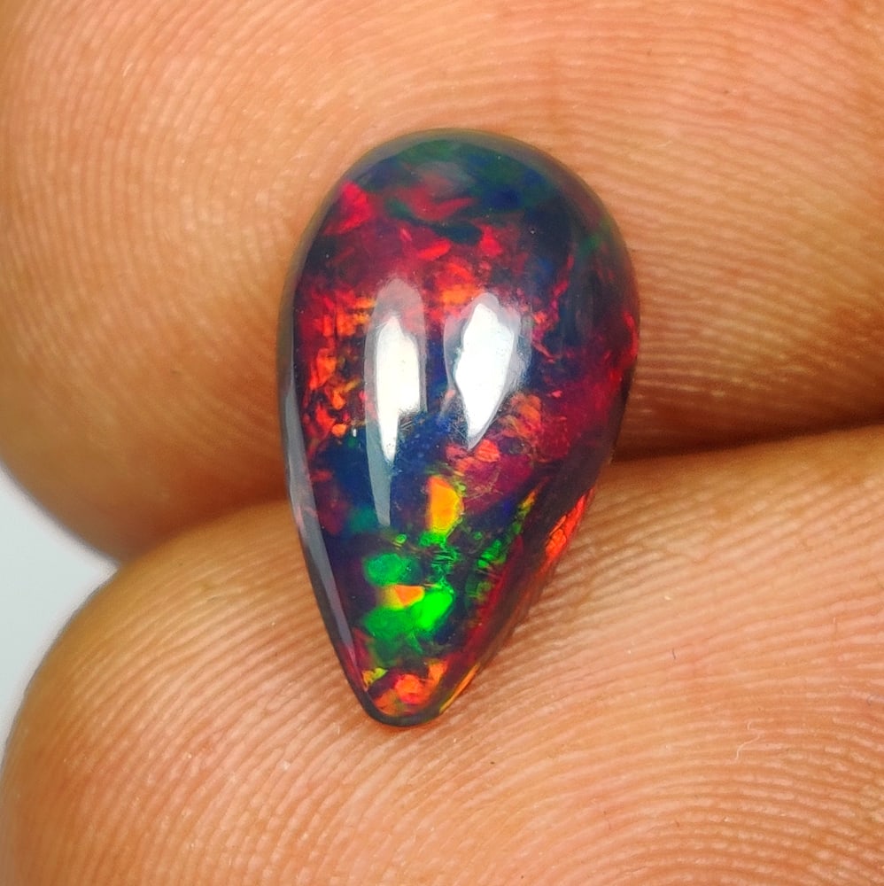 1.34 Ct Natural Black Flashing Fire Opal Pear Cab (1 of 2)