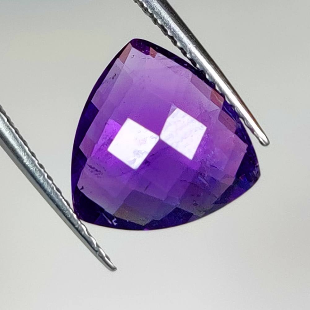 3.68 Ct Natural Purple Amethyst Trillion Checkerboard Cut: Weight - 3.68 Ct / Size - 10.90 x 10.80 x 5.40 mm / Shape - Trillion Checkerboard Cut / Color - Purple / Clarity - VVS / Origin -Brazil / Treatment - Heated