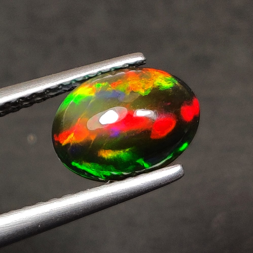 1.00 Ct Natural Black Flash Fire Opal OVal Cab (1 of 2)