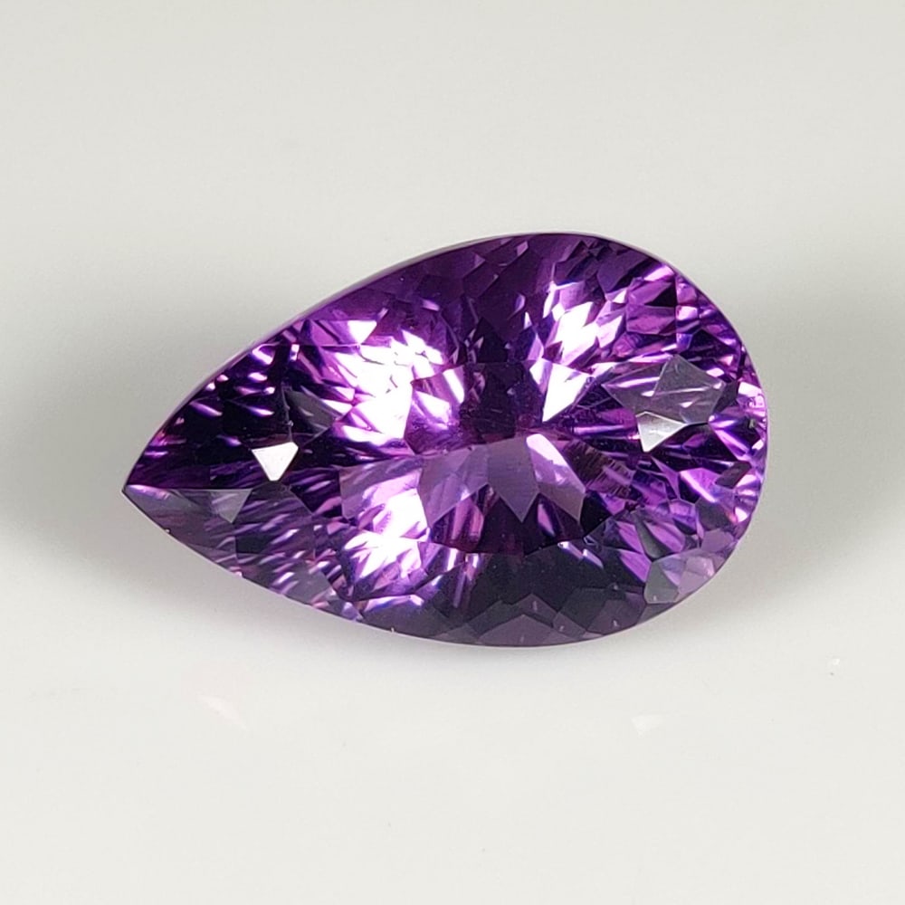 10.59 Ct Natural Purple Amethyst Pear Concave Cut: Weight - 10.59 Ct / Dimensions - 17.80 x 11.50 x 10.00 mm / Shape - Pear Cut / Color - Purple / Clarity - VVS / Origin -Brazil / Treatment - Heated