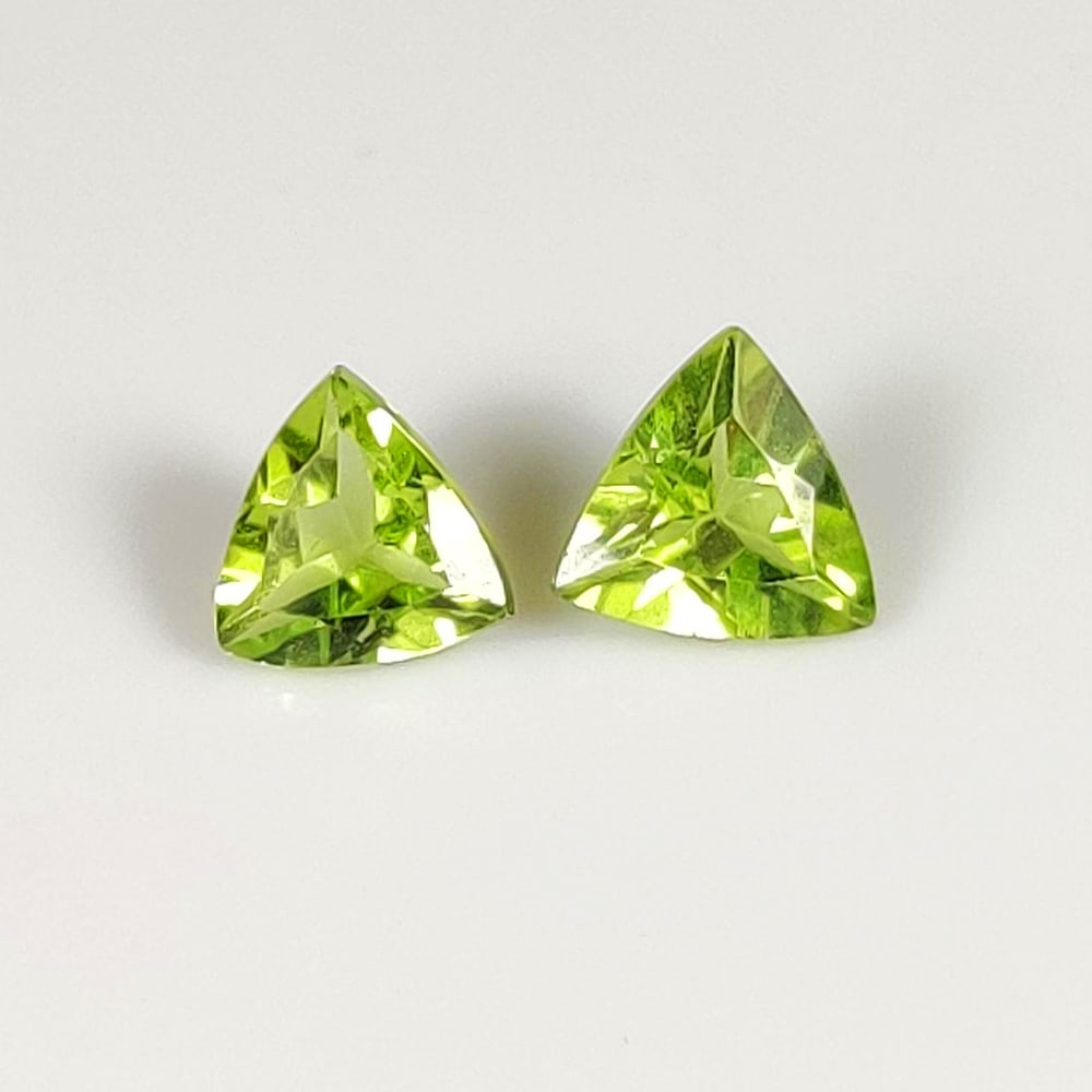 1.46 Ct Natural Green Peridot Trillion Cut Pair: Weight - 1.46 Ct / Dimensions - 5.60 x 5.60 x 3.00 mm / 2 Pc's / Shape - Trillion Cut / Color - Green / Clarity - VVS / Origin - Pakistan / Treatment - None