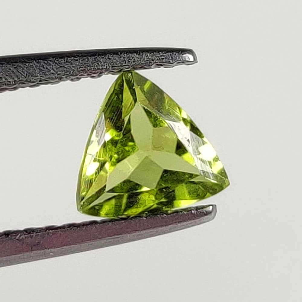 0.69 Ct Natural Green Peridot Trillion Cut: Weight - 0.69 Ct / Dimensions - 6.00 x 6.00 x 3.00 mm / Shape - Trillion Cut / Color - Green / Clarity - VVS / Origin - Pakistan / Treatment - None