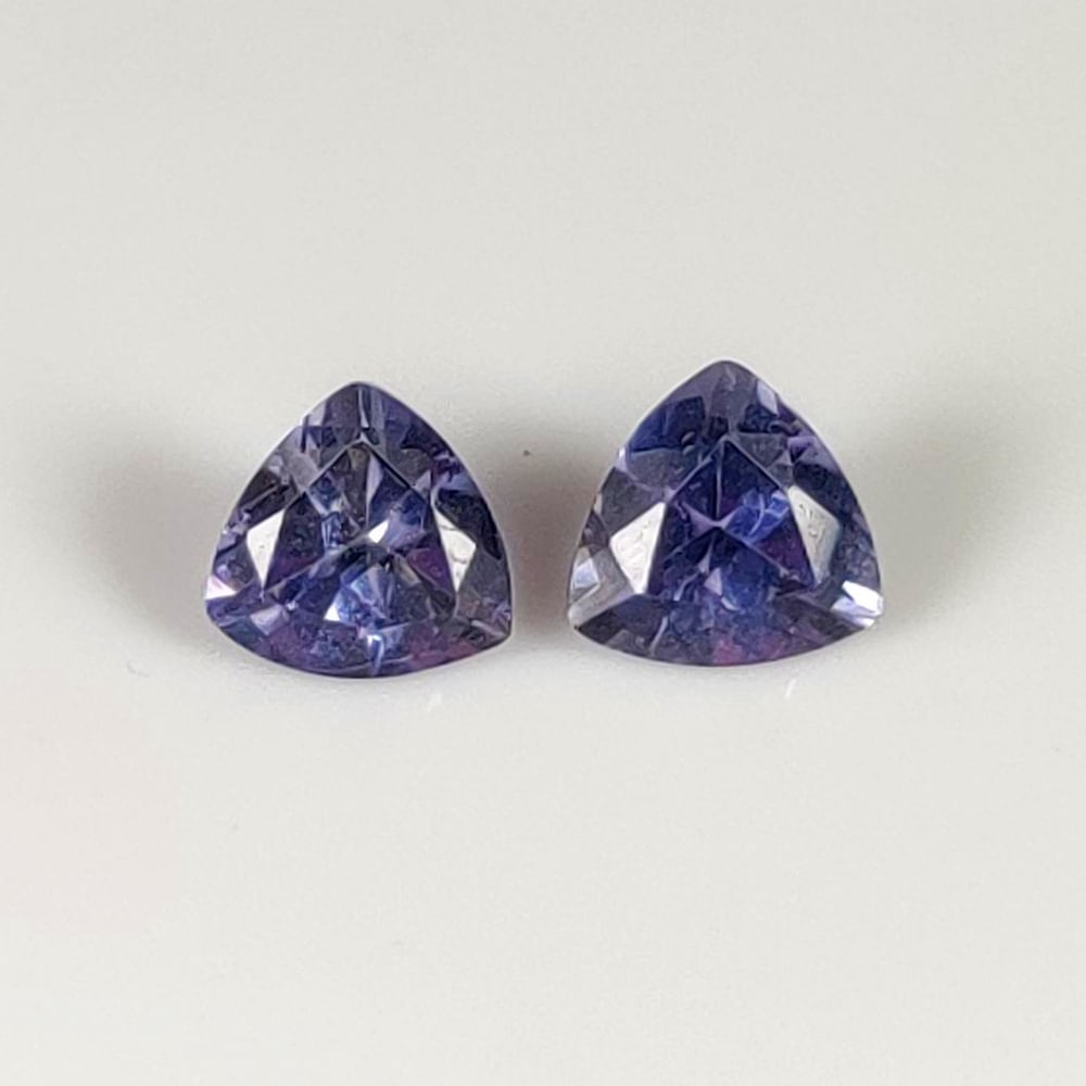 0.81 Ct Natural Violet-Blue Iolite Trillion Cut Pair: Weight - 0.81 Ct / Dimensions - 5.00 x 5.00 x 3.30 mm / 2 Pc's / Shape - Trillion Cut / Color - Violet / Clarity - VVS / Origin - Brazil / Treatment - None