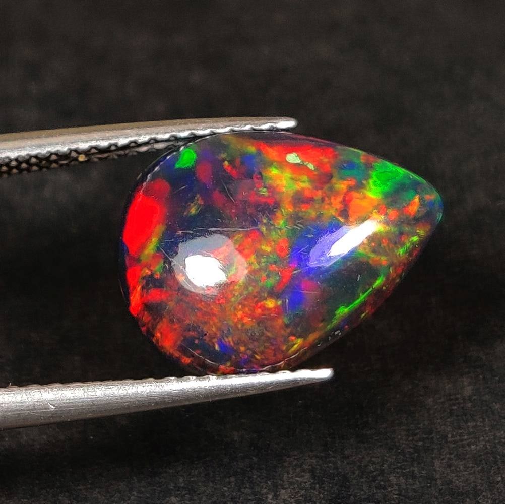 2.77 Ct Natural Black Flashing Fire Opal Pear Cab (1 of 2)