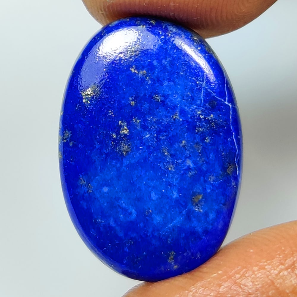 15.30 Ct Natural Blue Lapis Lazuli Oval Cab: Weight - 15.30 Ct / Dimensions - 23.00 x 15.40 x 4.30 mm / Shape - Oval Cab / Clarity - Obaque / Origin - Afghanisthan / Treatment - None