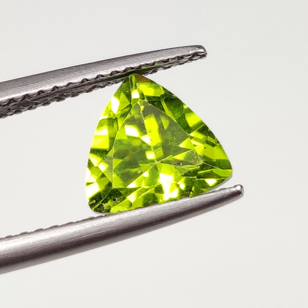 2.04 Ct Natural Green Peridot Trillion Cut: Weight - 2.04 Ct / Size - 8.00 x 8.00 x 5.00 mm / Shape - Trillion Cut / Color - Green / Clarity - VVS / Origin - Pakistan / Treatment - None