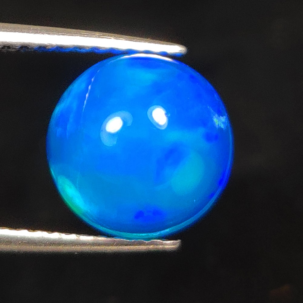 2.00 Ct Natural Blue Fire Opal Round Cab: Weight - 2.00 Ct / Size -8.90 x 8.90 x 5.30 mm / Shape - Round Cab / Color - Blue / Clarity - Translucent / Origin - Ethiopia / Treatment - Color Heated
