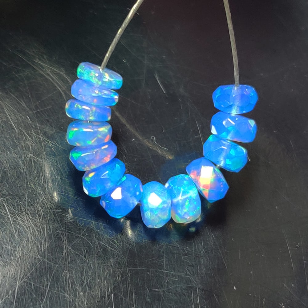 4.23 Ct Natural Blue Flashing Fire Opal Round Beads: Weight - 4.23 Ct / Dimensions - 4.80 - 5.20 mm / Shape - Round Beads / Color - Blue / Clarity - Translucent / Origin - Ethiopia / Treatment - Heated