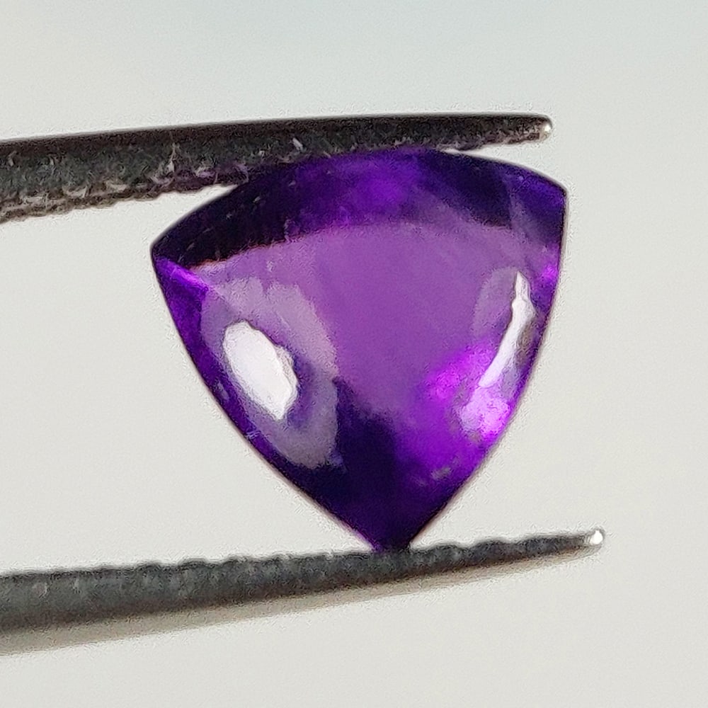 1.81 Ct Natural Purple Amethyst Trillion Cab: Weight - 1.81 Ct / Dimensions - 8.00 x 7.90 x 5.40 mm / Shape - Trillion Cab / Color - Purple / Clarity - VVS / Origin -Brazil / Treatment - Heated