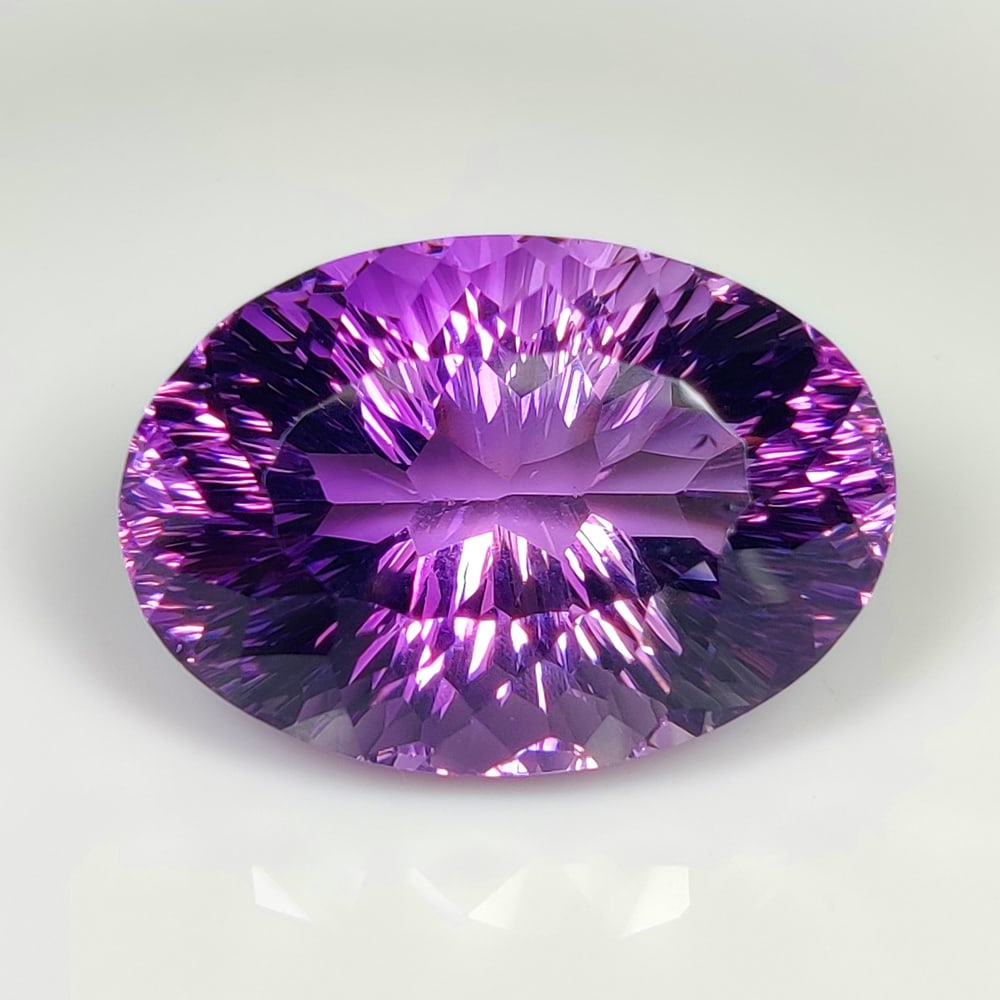 65.19 Ct Natural Purple Amethyst Oval Cut: Weight - 65.19 Ct / Dimensions 31.00 x 22.00 x 8.00 mm / Shape - Oval Cut / Color - Purple / Clarity - VVS / Origin - Brazil / Comments - Heated