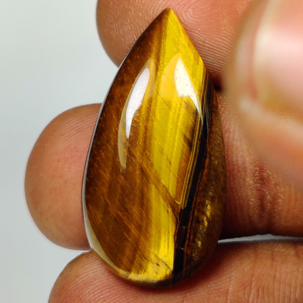 22.07 Ct Natural Tiger Eye Pear Cab: Weight - 22.07 Ct / Dimensions - 28.00 x 15.10 x 6.40 mm / Top Class Quality / Pear Cab / Origin - Burmese / Comments - None