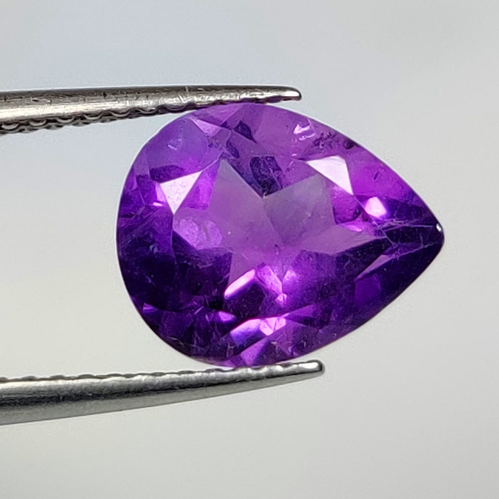 2.34 Ct Natural Purple Amethyst Pear Cut: Weight - 2.34 Ct / Dimensions - 10.00 x 8.00 x 5.60 mm / Shape - Pear Cut / Color - Purple / Clarity - VVS / Origin -Brazil / Treatment - Heated