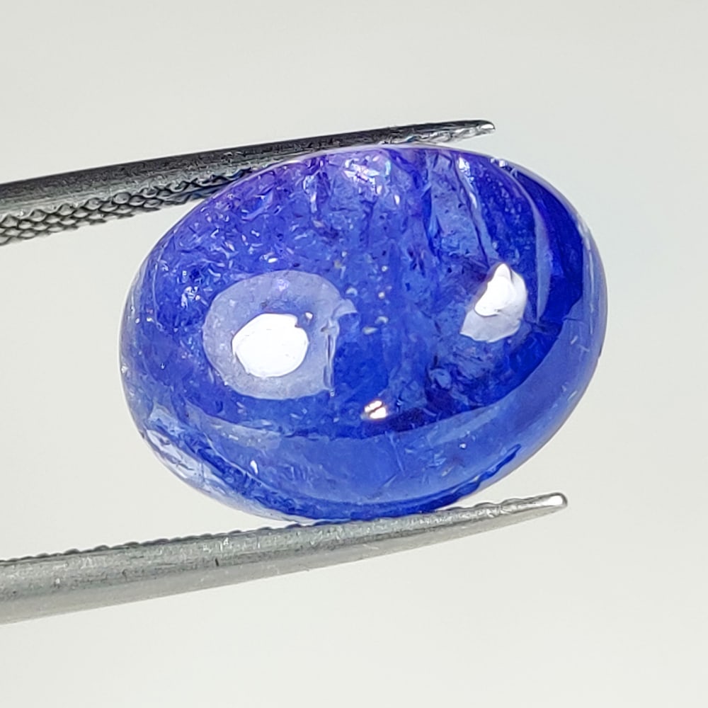 10.34 Ct Natural Tanzanite Oval Cab: Weight : 10.34 Ct / Dimensions : 14.80 x 11.20 x 6.80 mm / Shape : Oval Cab / Color : Purplish Blue / Transparency : Transparent / Treatment : Heated