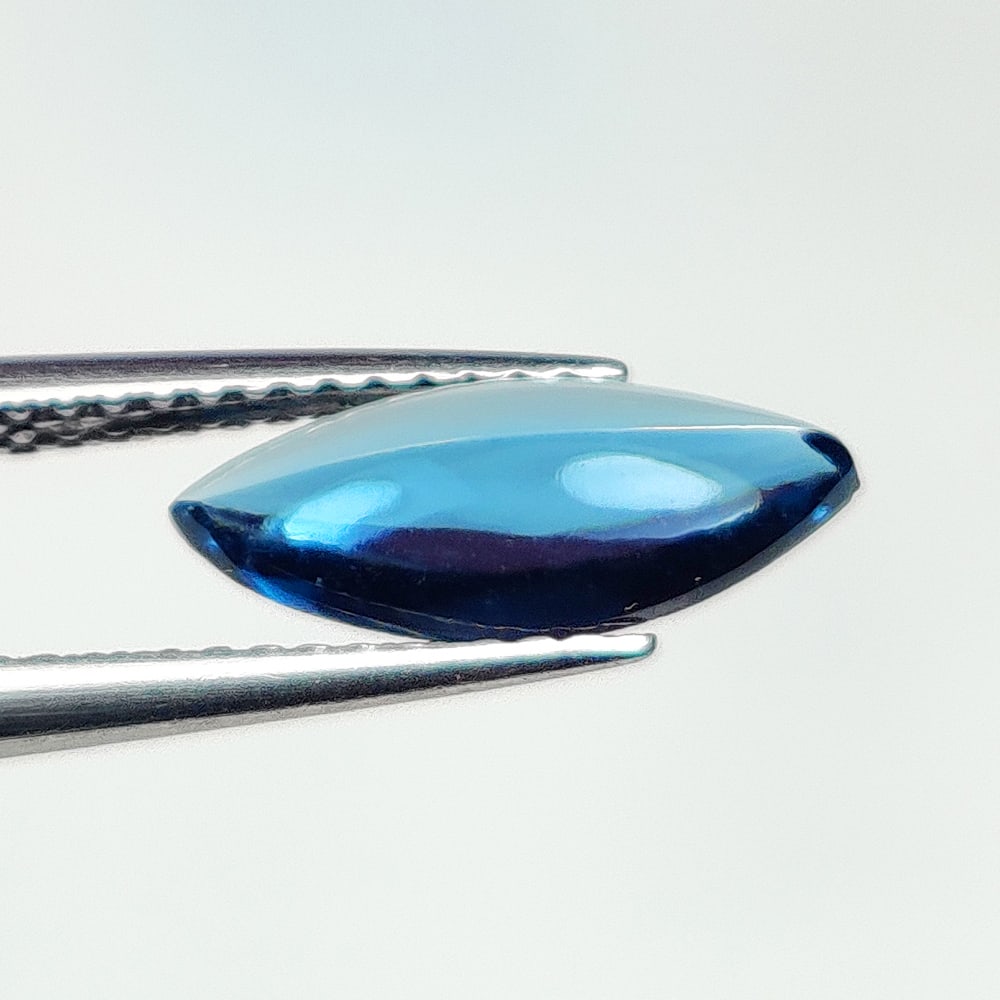 1.44 Ct Natural London Blue Topaz Marquise Cab: Weight - 1.44 Ct / Size - 12.20 x 5.10 x 3.10 mm / Shape - Marquise Cab / Color - Deep Blue / Clarity - VVS / Origin - Brazil / Treatment - Irradiated