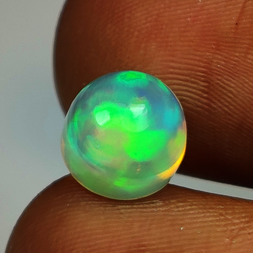 2.25 Ct Natural Multicolor Welo Opal Top Fire Round Cab: Weight - 2.25 Ct / Size - 8.10 x 8.10 x 6.30 mm / Shape - Round Cab / Color - Multicolor / Clarity - Translucent / Origin - Ethiopia / Treatment - None
