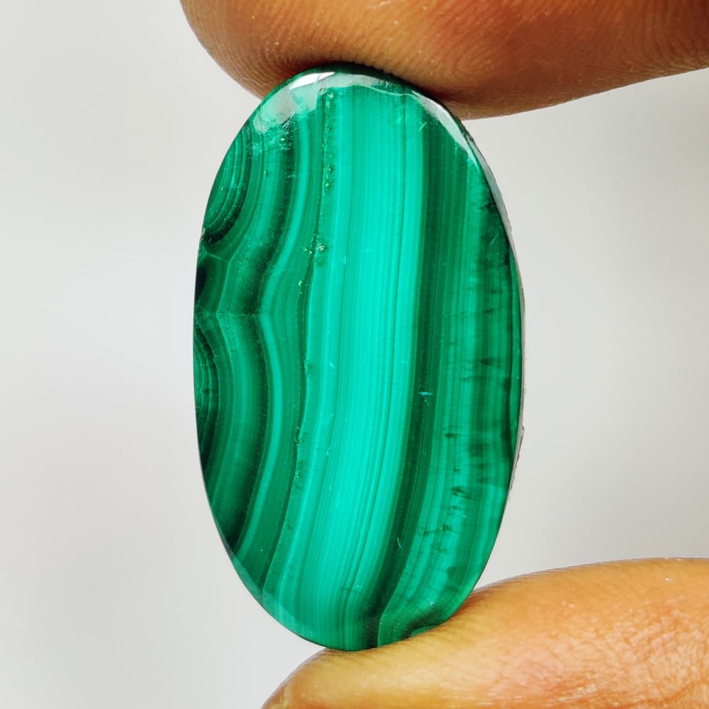 23.43 Ct Natural Green Malachite Oval Cab: Weight - 23.43 Ct / Size - 27.00 x 14.40 x 4.40 mm / Shape - Oval Cab / Color - Green / Clarity - Opaque / Origin - Russia / Treatment - None