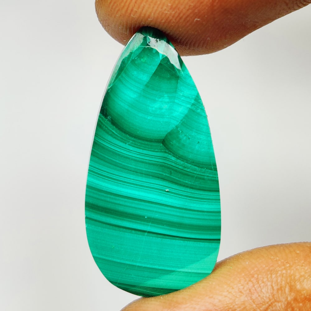 25.45 Ct Natural Green Malachite Pear Cab: Weight - 25.45 Ct / Size - 31.00 x 14.10 x 4.50 mm / Shape - Pear Cab / Color - Green / Clarity - Opaque / Origin - Russia / Treatment - None