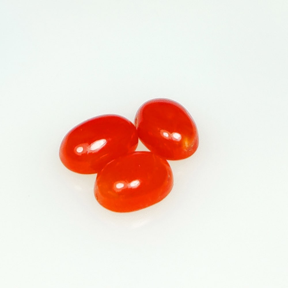 2.64 Ct Natural Red Coral Oval Cab Set: Weight - 2.64 Ct / Dimensions - 7.0x5.2 - 7.1x5.3 mm / 3 Pc's / Shape - Oval Cabochon / Color - Red / Clarity - Opaque / Origin - Italy / Treatment - None