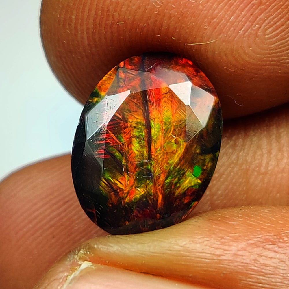 3.03 Ct Natural Black Flashing Fire Opal Oval Cab: Weight - 3.03 Ct / Dimensions - 12.20 x 9.20 x 6.10 mm / Shape - Oval Cab / Color - Black / Clarity - Translucent / Origin - Ethiopia / Treatment - Color Smoked