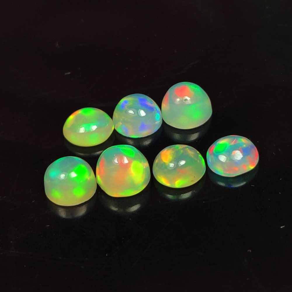 4.42 Ct Natural Multicolor Welo Opal Top Fire Round Cab Set: Weight - 4.42 Ct / Size - 5.90 - 6.10 mm / 7 Pc's / Shape - Round Cab / Color - Multicolor / Clarity - Translucent / Origin - Ethiopia / Treatment - None