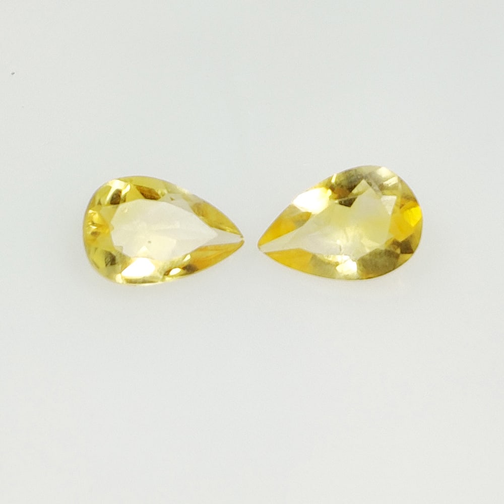 1.85 Ct Natural Yellow Citrine Pear Cut Pair: Weight - 1.85 Ct / Size -8.80 x 5.80 x 3.40 mm / 2 Pc's / Shape - Pear Cut / Color - Yellow / Clarity - VVS / Origin - Brazil / Treatment - Heated