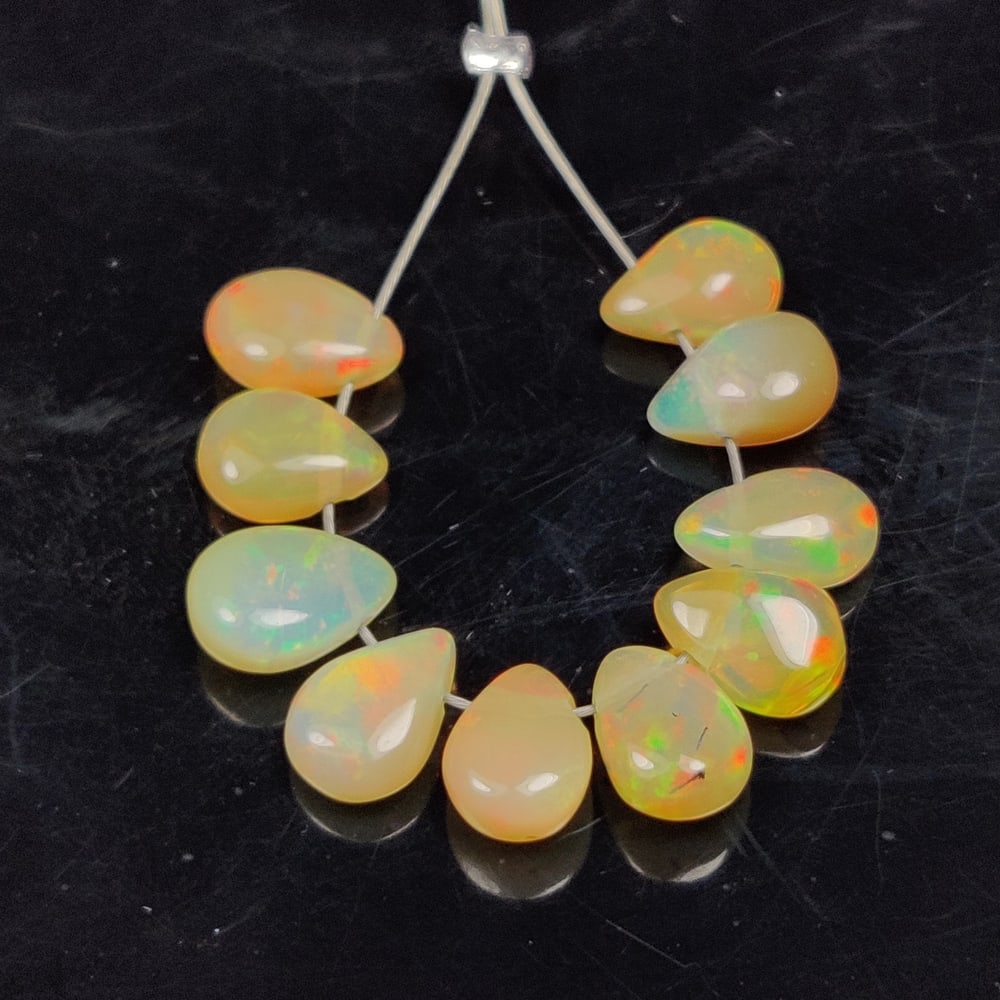 5.14 Ct Natural Multi-Color Welo Opal Pear Beads: Weight - 5.14 Ct / Size - 6.8x5.1 - 7.1x5.3 mm / 10 Pc's / Shape - Pear Beads / Color - Multicolor / Clarity - Translucent / Origin - Ethiopia / Treatment - None