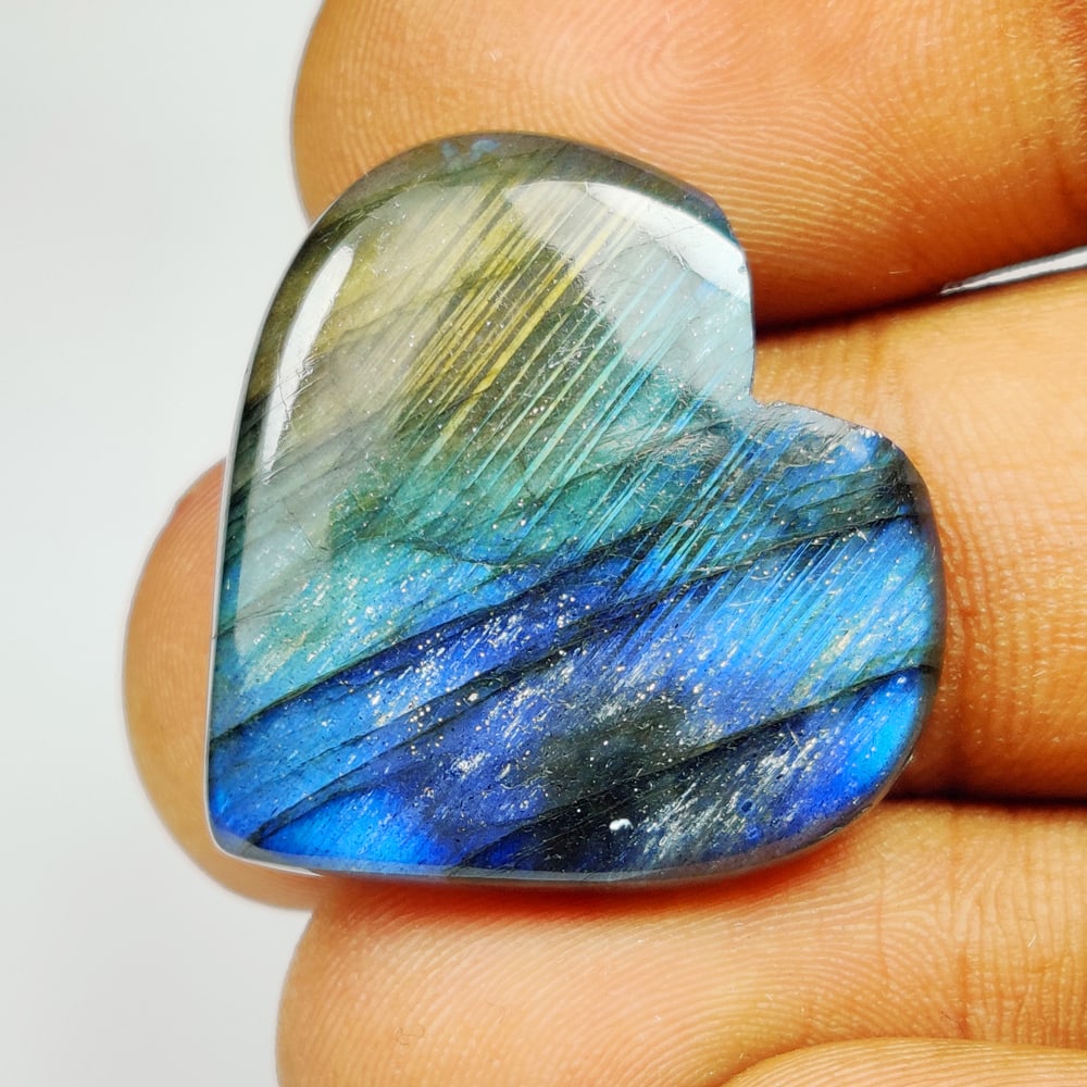 24.38 Ct Natural Labradorite Heart Cab: Weight - 24.38 Ct / Size - 27.00 x 25.00 x 5.10 mm / Shape - Heart Cab / Clarity - Opaque / Origin - Africa / Treatment - None