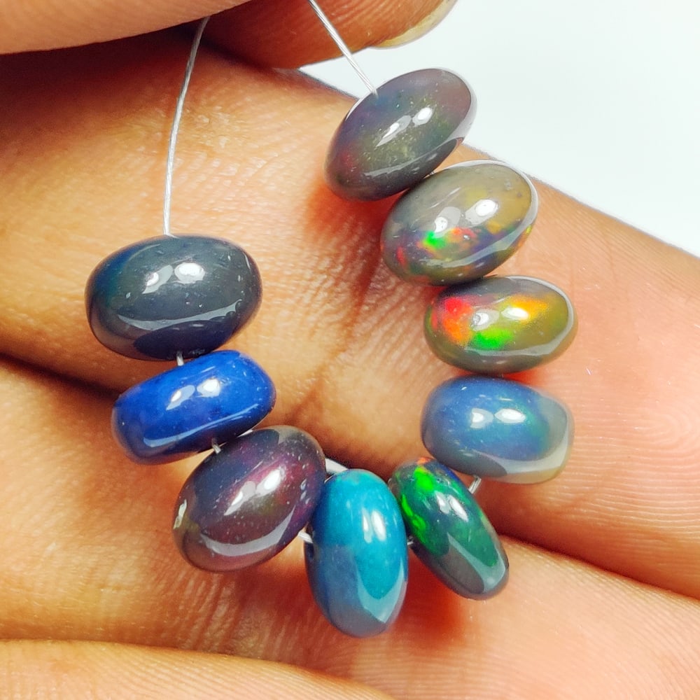10.80 Ct Natural Black Flashing Fire Opal Round Beads: Weight - 10.80 Ct / Dimensions - 7.10 - 7.90 mm / 9 Pc's / Shape - Round Beads / Color - Black / Clarity - Translucent / Origin - Ethiopia / Treatment - Color Smoked