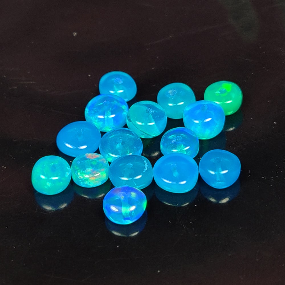 6.53 Ct Natural Blue Fire Opal Round Beads: Weight - 6.53 Ct / Dimensions - 5.00 - 5.90 mm / 15 Pc's / Shape - Round Drilled / Color - Blue / Transparency - Translucent / Origin - Ethiopia / Treatment - Color Heated