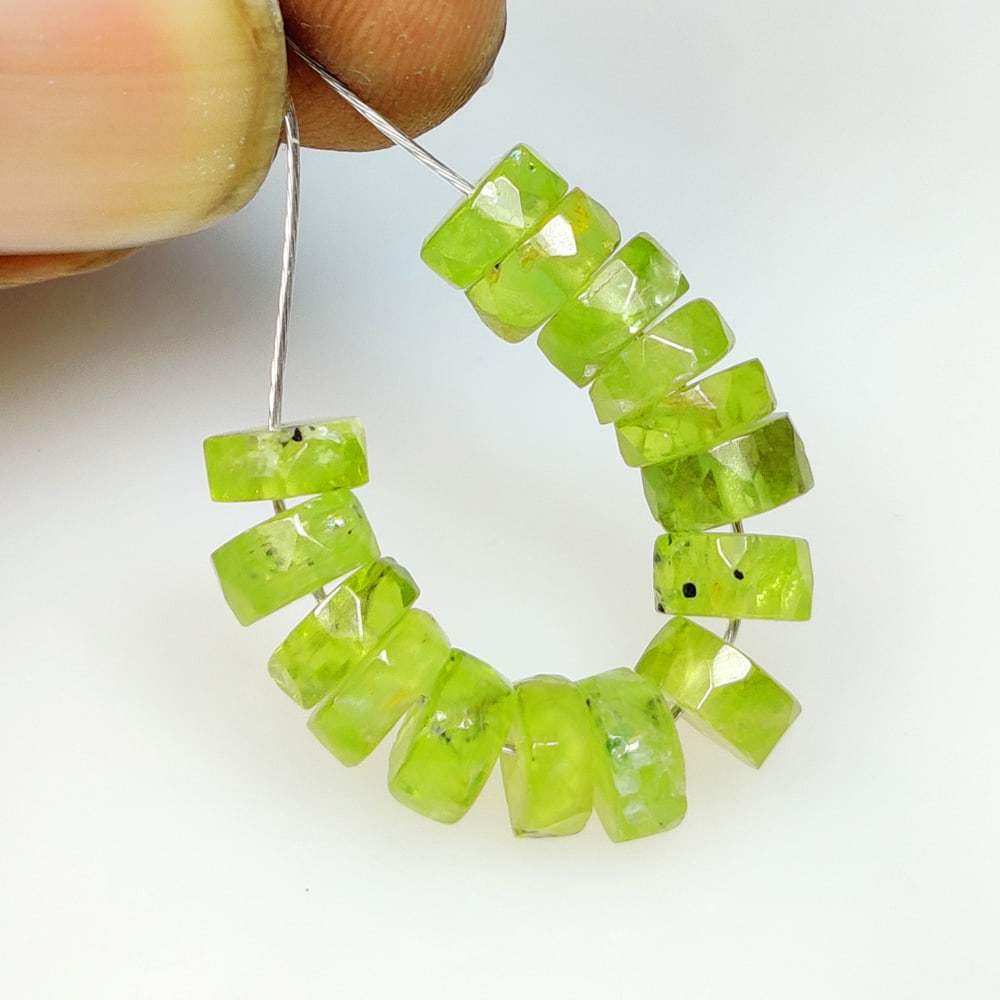 15.11 Ct Natural Green Peridot Round Cut Beads: Weight - 15.11 Ct / Dimensions - 5.60 - 6.10 mm / 15 Pc's / Shape - Round Cut Beads / Color - Green / Clarity - VVS / Origin - Pakistan / Treatment - None