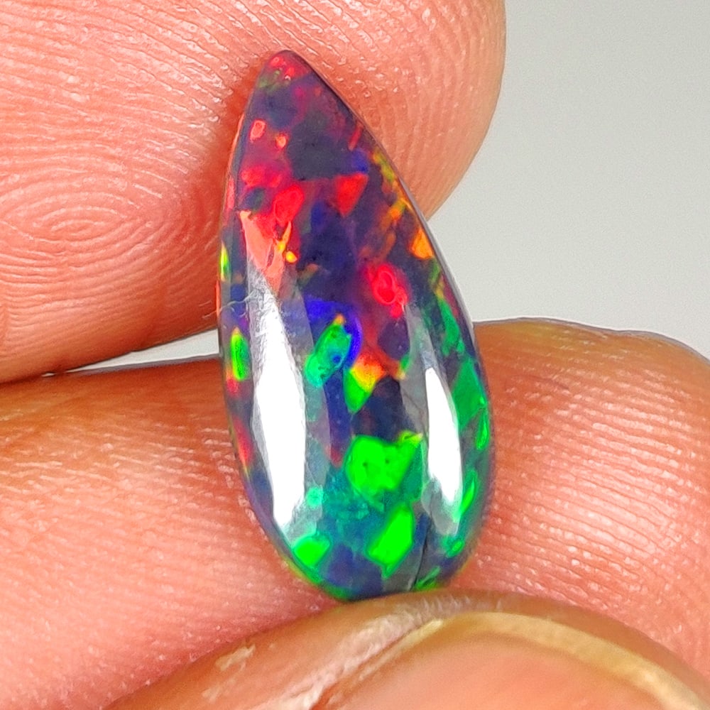 1.31 Ct Natural Black Flashing Fire Opal Pear Cab (1 of 2)