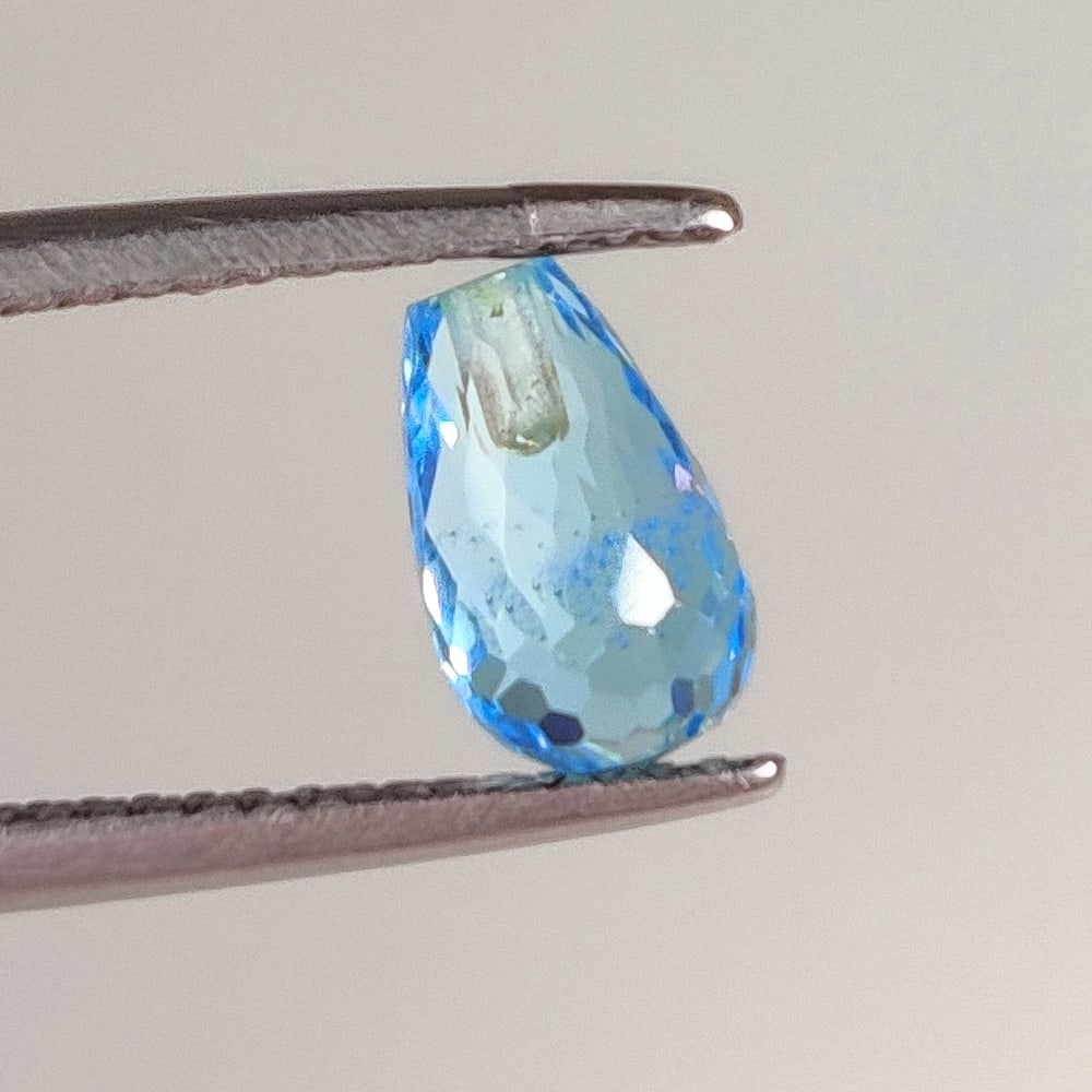 1.79 Ct Natural Blue Topaz Pear Drop: Weight - 1.79 Ct / Dimensions 8.20 x 5.00 x 5.00 mm / Shape Pear Dop / Color - Blue / Clarity - VVS / Origin - Brazil / Treatment - Irradiated