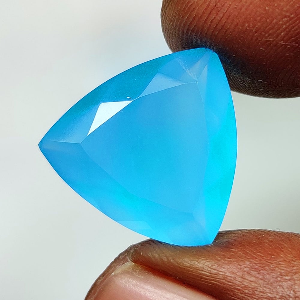 10.58 Ct Natural Blue Onyx Trillion Cut: Weight - 10.58 Ct / Dimensions - 17.10 x 16.90 x 7.50 mm / Shape - Trillion Cut / Clarity - Opaque / Origin - Brazil / Comments - None