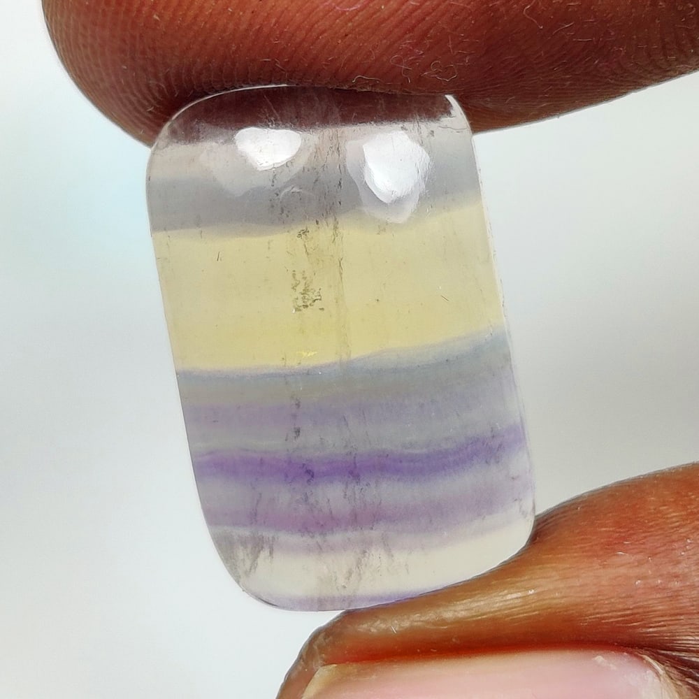 12.95 Ct Natural Multi-Color Fluorite Cushion Cab: Weight - 12.95 Ct / Dimensions - 19.60 x 12.40 x 5.00 mm / Shape - Cushion Cab / Color - Multi-Color / Clarity - VVS / Origin -Brazil / Treatment - None