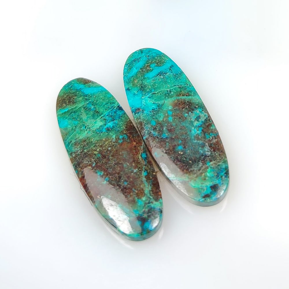 25.68 Ct Natural Chrysocola Shattuckite Oval Cab Pair: Weight - 25.68 Ct / Dimensions - 31.00 x 11.10 x 3.90 mm / 2 Pc's / Shape - Oval Cab / Clarity - Opaque / Origin - Brazil / Treatment - None