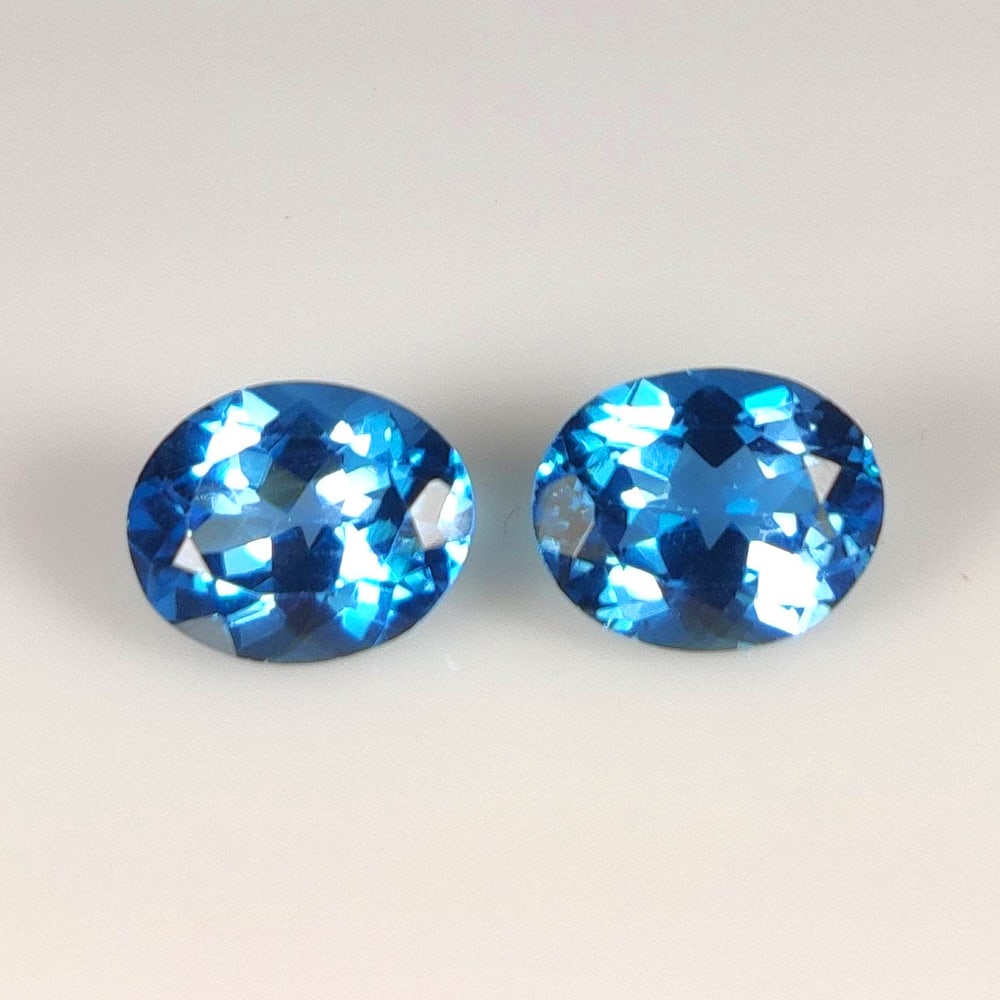 6.72 Ct Natural London Blue Topaz Oval Cut Pair: Weight - 6.72 Ct / Size - 10.0x8.1 - 10.1x8.1 mm / 2 Pc's / Shape - Oval Cut / Color - Blue / Clarity - VVS / Origin - Brazil / Treatment - Irradiated