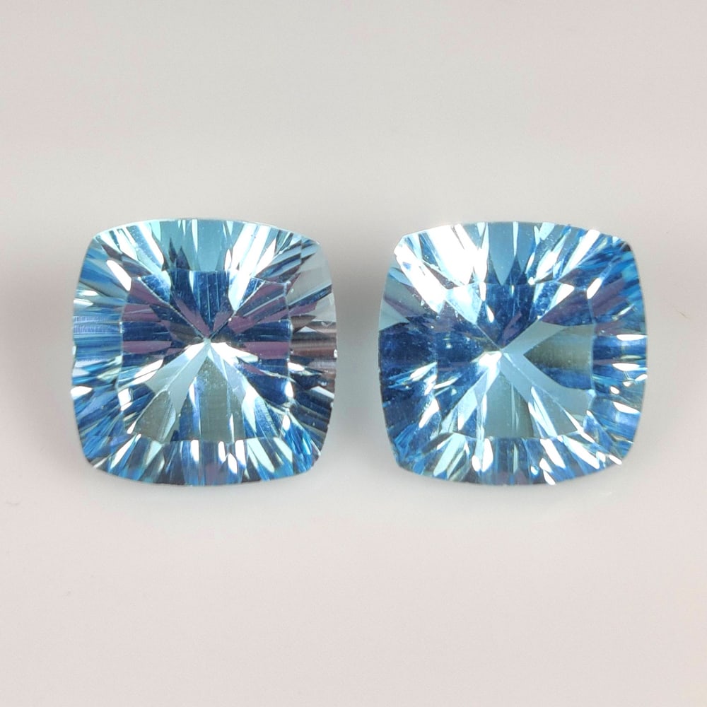 12.93 Ct Natural Blue Topaz Cushion Cut Pair: Weight - 12.93 Ct / Size - 11.1x10.9 - 11.1x11.0 mm / 2 Pc's / Shape - Cushion Cut / Color - Blue / Clarity - VVS / Origin - Brazil / Treatment - Irradiated