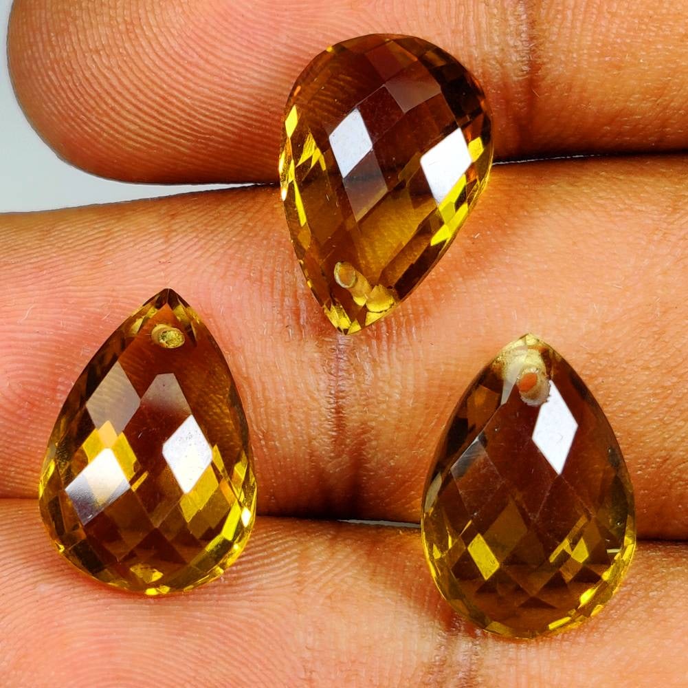16.16 Ct Natural Honey Quartz Drilled Pear Checkerboard Cut Set: Weight - 16.16 Ct / Dimensions - 14.1x9.9 - 14.2x10.1 mm / 3 Pc's / Shape & Cut - Drilled Pear Checkerboard Cut / Color - Yellow / Clarity - VVS / Origin - Brazil / Comments - None