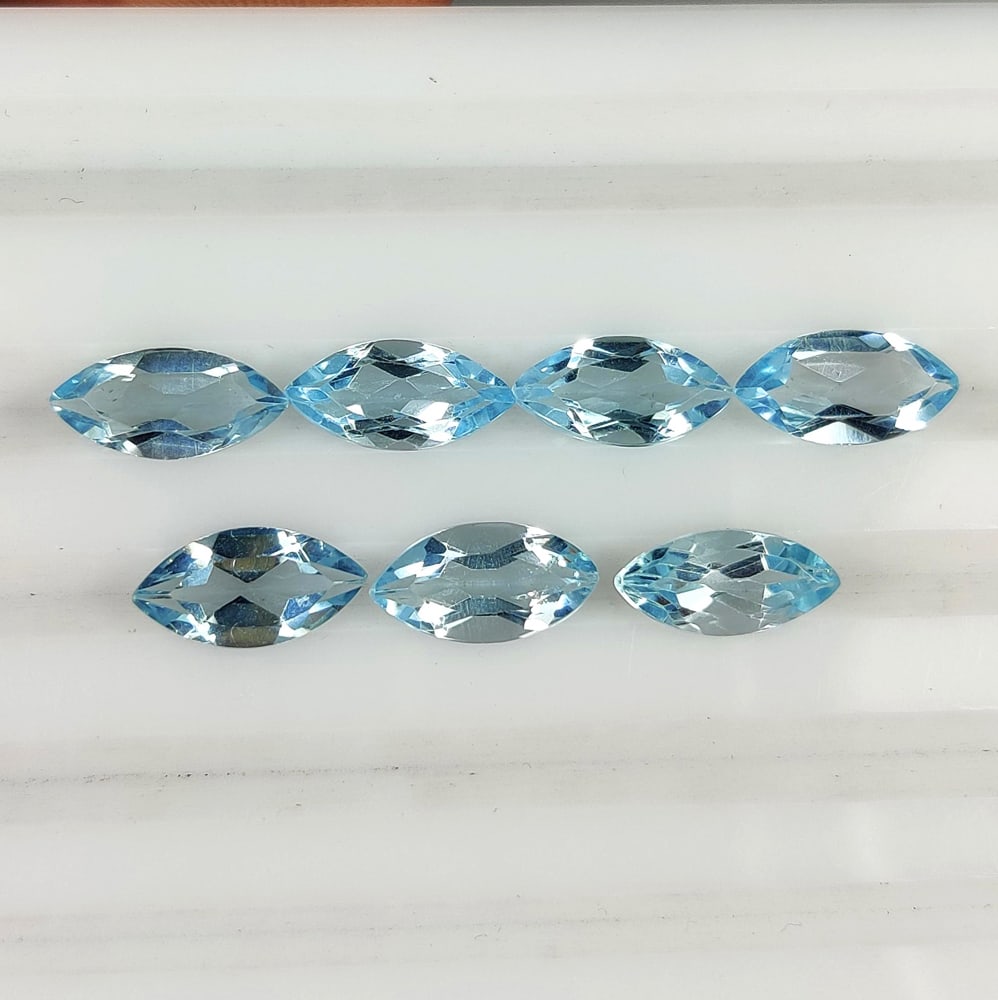 8.26 Ct Natural Blue Topaz Marquise Cut Set: Weight - 8.26 Ct / Dimensions - 10.0x5.0 - 10.1x5.1 mm / 7 Pc's / Shape - Marquise Cut / Color - Blue / Clarity - VVS / Origin - Brazil / Treatment - Irradiated