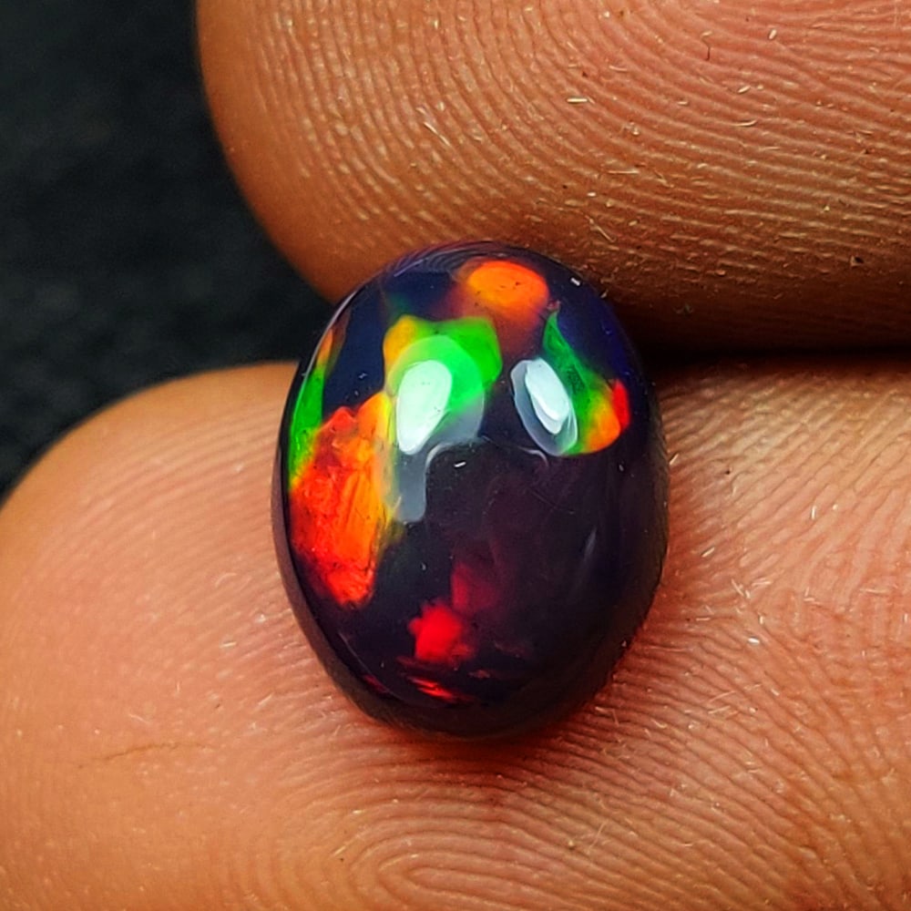 1.53 Ct Natural Black Flashing Fire Opal Oval Cab (1 of 2)