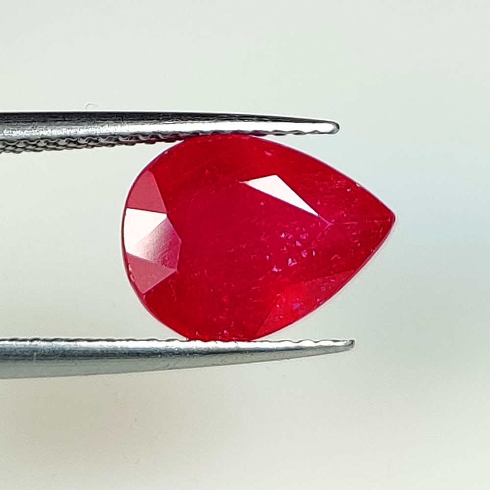 4.60 Ct Natural Blood Red Ruby Pear Cut: Weight - 4.60 Ct / Dimensions - 11.70 x 8.80 x 5.80 mm / Shape - Pear Cut / Color - Red / Clarity - SI / Origin - Mozambique / Treatment - Color Enhanced by Glass Filling